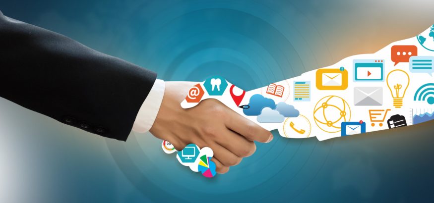Two people shaking hands, one in a business suite and one's arm is made up of social icons and marketing tools.